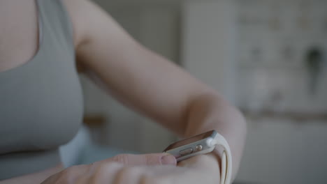 woman adjusting smartwatch on wrist