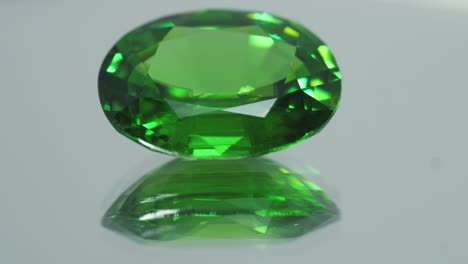 polished green gemstone rotates and sparkles