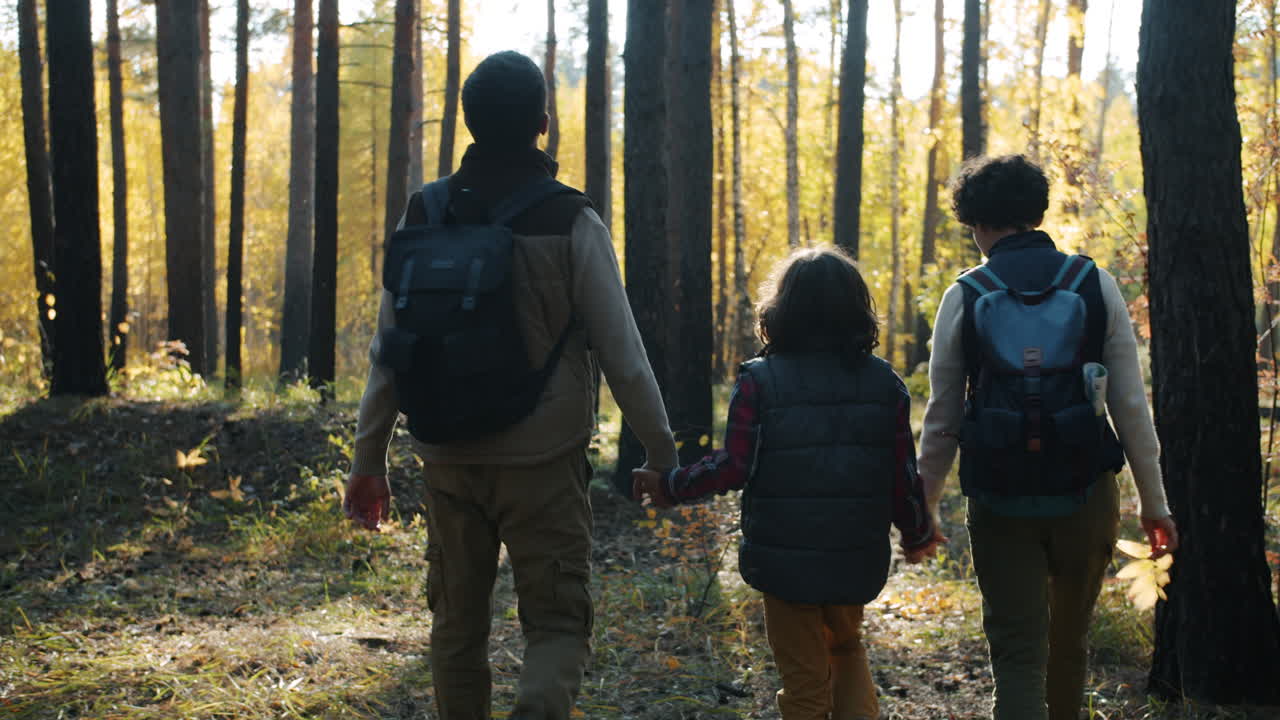 Family Hiking in Autumn Forest