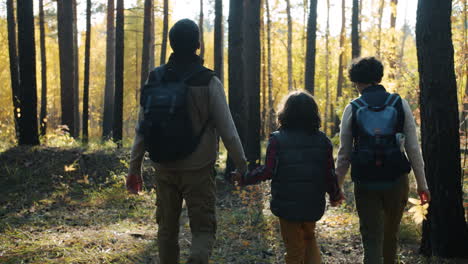 family hiking in autumn forest
