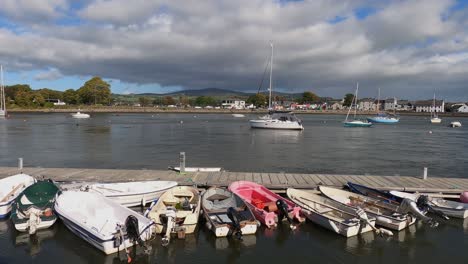 ebbing river tide flows past boats in small irish marina, dungarvan