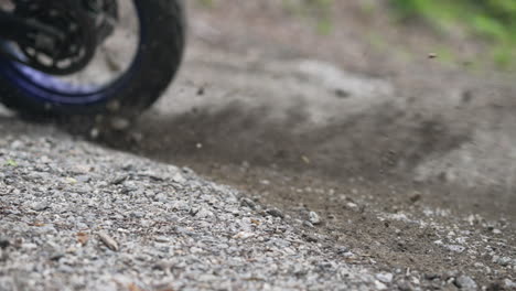 motorcycle tire spinning and taking off on a dirt off road