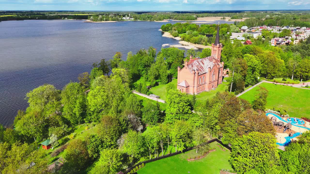 Lush Nature At The Coastal Landscape With Evangelical Reformed Church Of Lithuania. Aerial Drone Shot