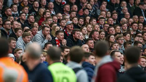 a sea of emotion: capturing the passion and anticipation of a crowd at a sports event as fans react to the action unfolding on the field