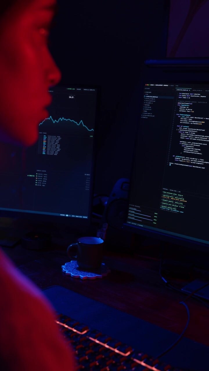 Software Developer Coding on Computer in Dark Office
