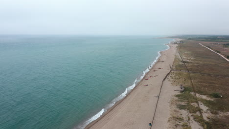 Sandy-beach-cloudy-day-Occitanie-France-aerial-shot