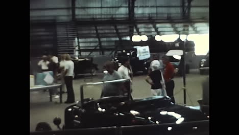 person standing next to car in 1970s usa parking lot. circa usa - 1970s: a photo capturing a person standing alongside a car in a parking lot during an old car show in 1970s usa.
