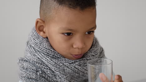young boy drinking water