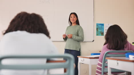teacher explaining math to students in classroom