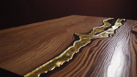 close-up of a handcrafted wooden surface with a shimmering gold resin inlay