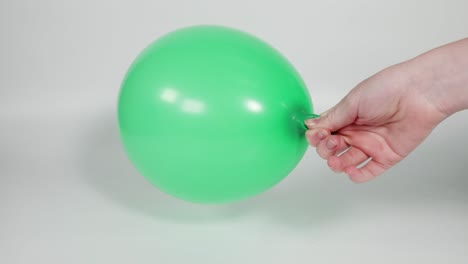 sequence of inflating and deflating a green balloon