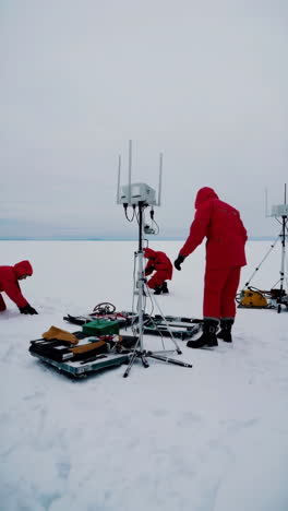 scientists deploying monitoring equipment on arctic ice