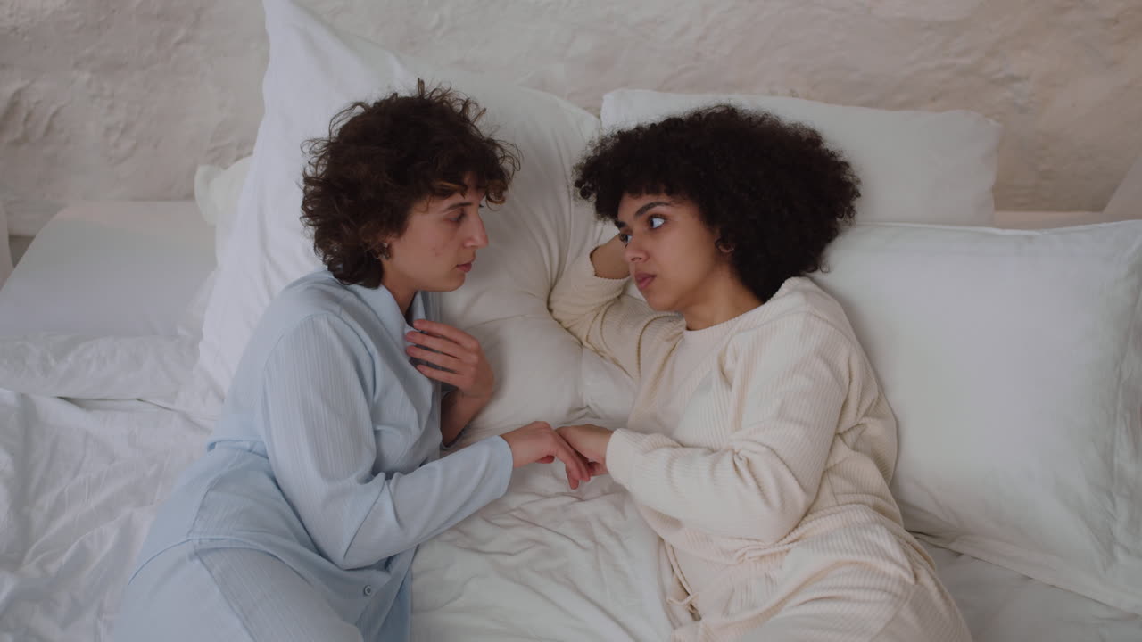 Happy couple talking on bed