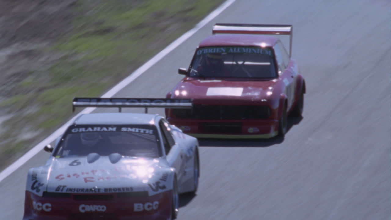 Racing cars compete on a circuit track 3