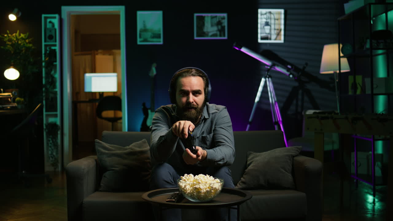 Man in disbelief after losing while playing videogames, receiving game over