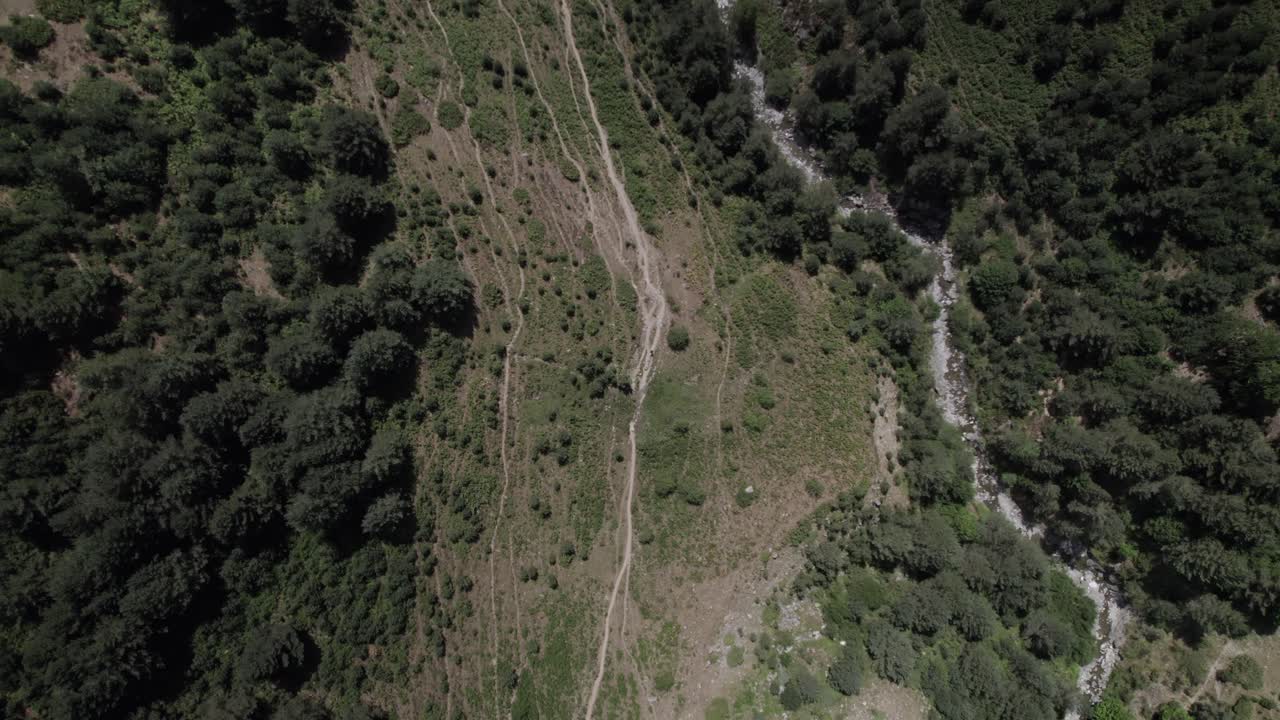 4K top-down descending drone shot over the Western Valleys Natural Park in the Aragonese Pyrenees, Spain. A cinematic aerial view of the prairie leading to Ibón de Acherito.
