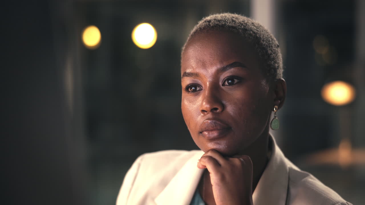 Thoughtful Young Black Businesswoman Looking Away in a Modern Office