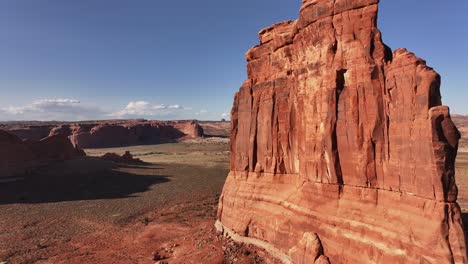 A-large-rock-formation-stands-prominently-in-the-middle-of-Utah's-desert-near-Moab,-USA,-embodying-the-stark-beauty-and-solitude-of-the-landscape