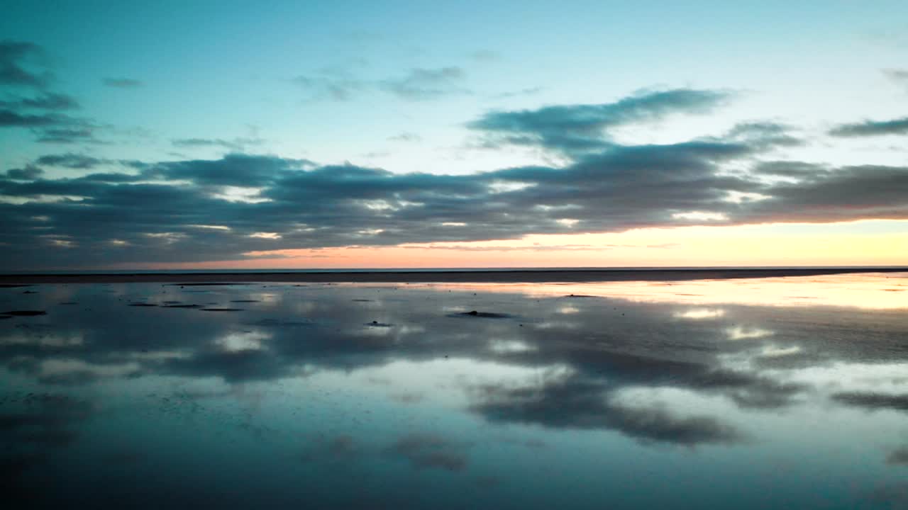 water reflection sunset on the beach in Iceland aerial