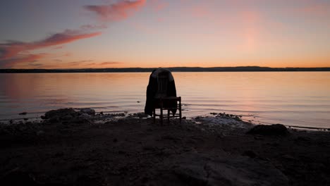 lonely chair at sunset on the beach