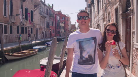 couple enjoying ice cream in venice canal