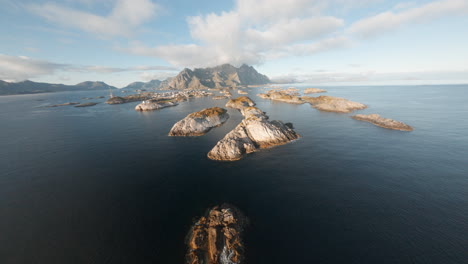 fpv drone aerial of henningsvær, lofoten islands in norway, impressive low flight