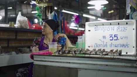 woman selling fish at a market