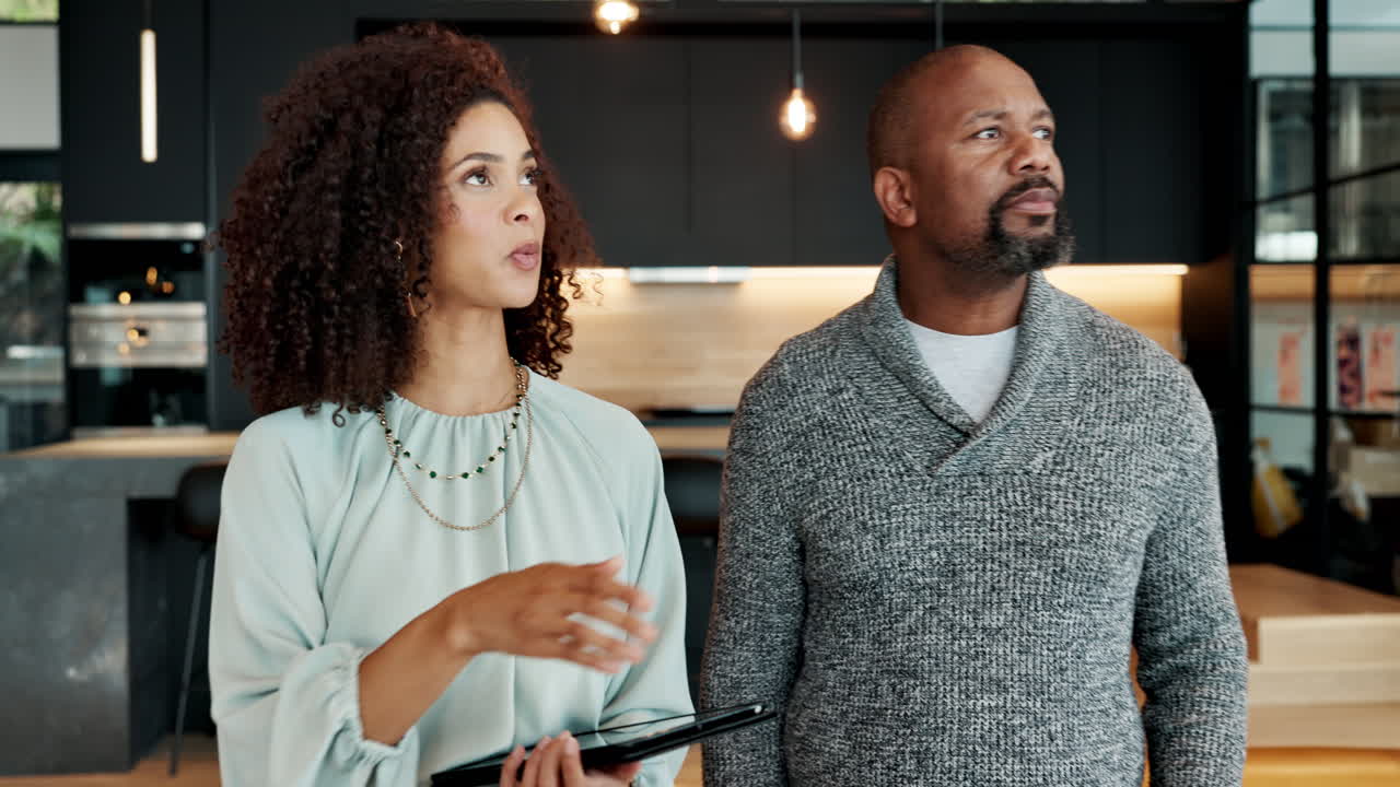 Couple inspecting new home with real estate agent