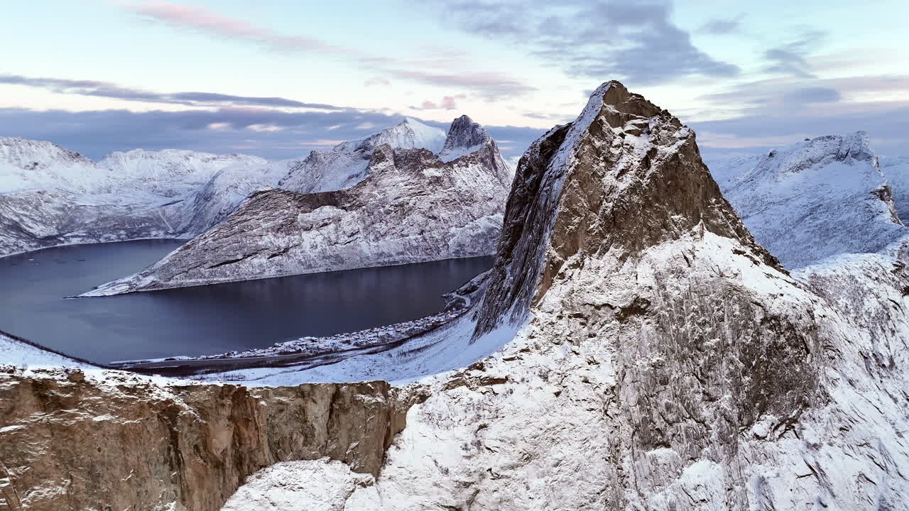 Cinematic aerial view of Hesten, one of the most photographed peaks on Senja Island, Norway, its horse-like shape towering over fjords and rugged Arctic landscapes in Troms og Finnmark County
