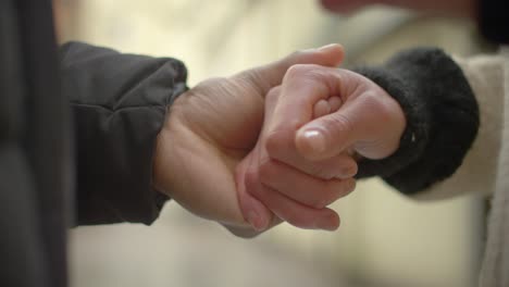 couple holding hands close up