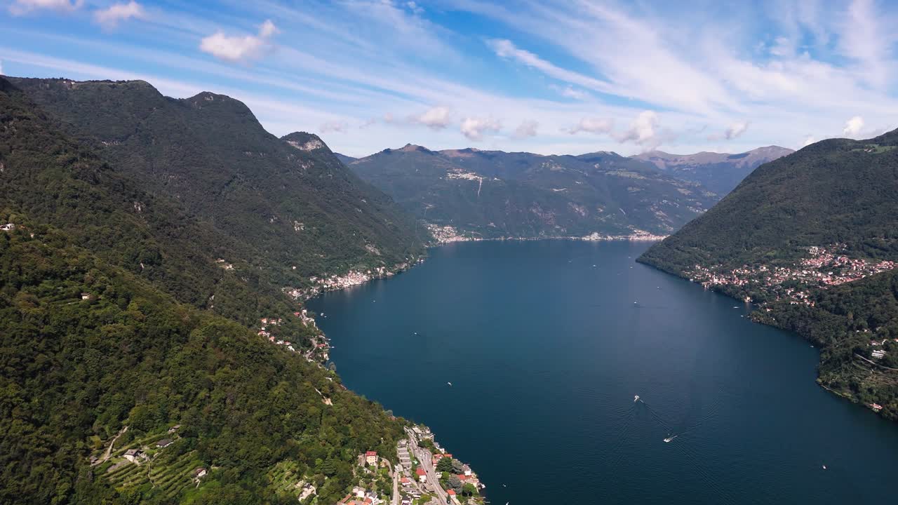 View of mountains with small clouds above and Lake Como, Italy