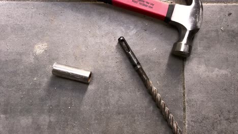 Zooming out from tools at construction site, hammer and drilling metal patrons, used for drilling holes in different material, repair and maintenance craftsmanship concept