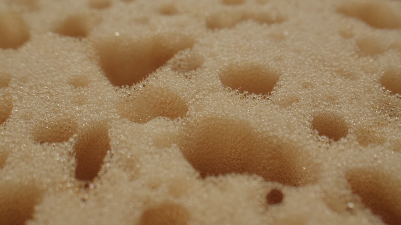 Macro View of Bubbling Foam on a Beige Sponge Texture