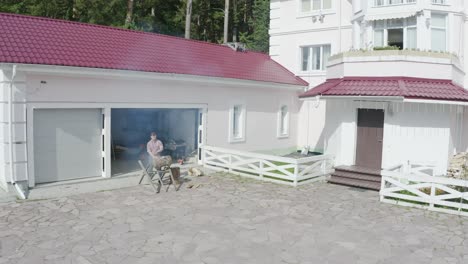 man cooking outdoors at a home