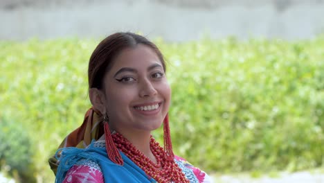 slow motion cinematic portrait of a happy young hispanic indian girl looking at the camera and smiling