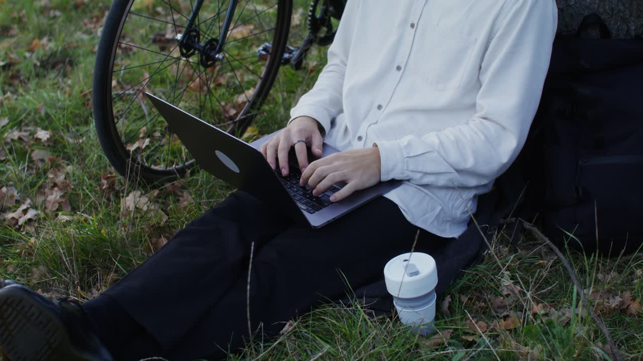 Person working on a laptop in a park