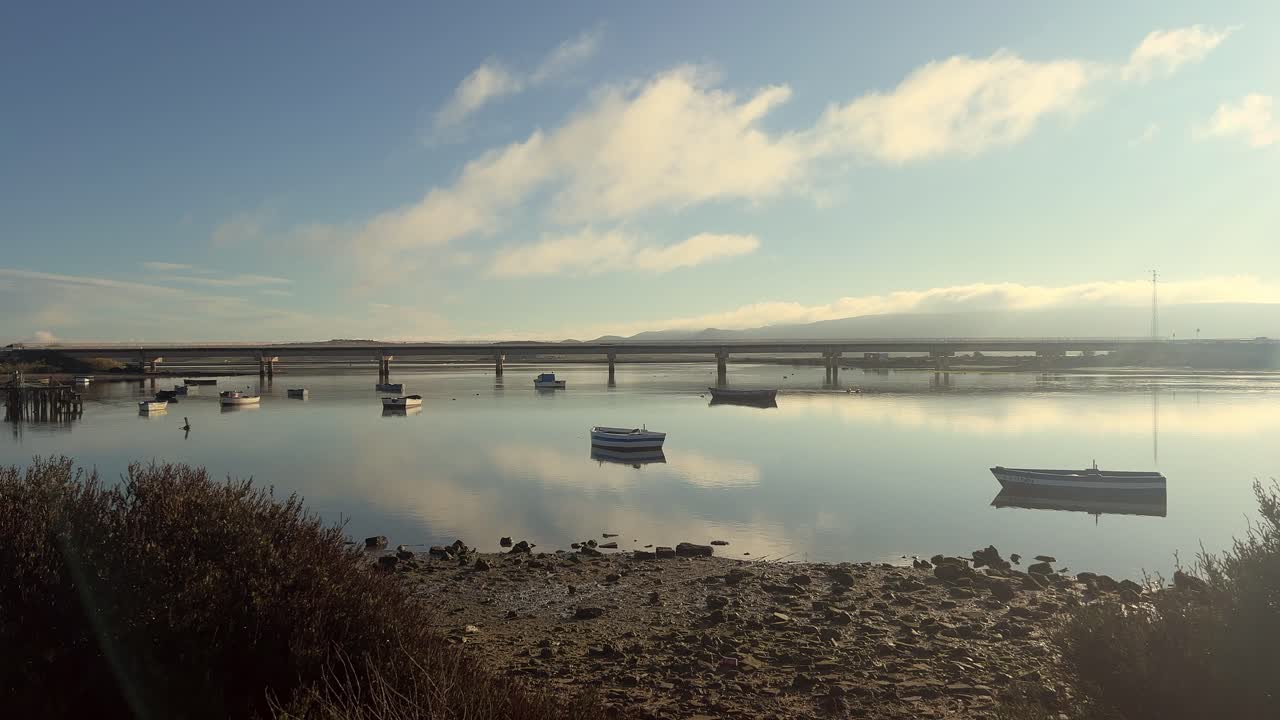 Peaceful River Scene with Boats and Bridge