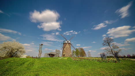 beautiful stone millhouse in vibrant rural landscape, time lapse view