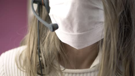 woman wearing headset and face mask close up shot