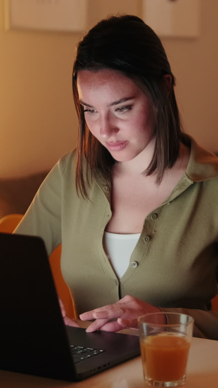 Woman Working From Home on Laptop at Night