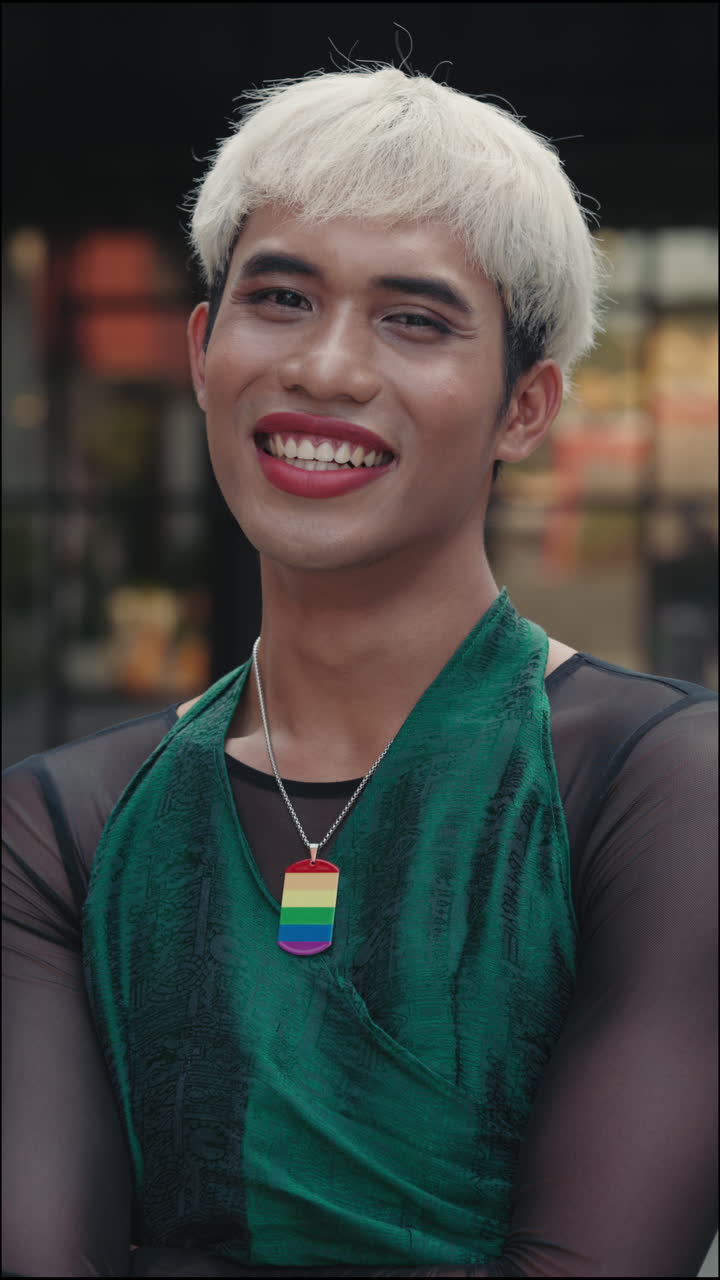 Portrait of a Happy Gay Man Wearing Pride Necklace