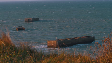 remains of the mulberry harbour, used by the allied army in the d-day, during the world war ii