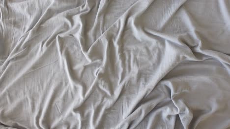 wrinkled grey bed sheets