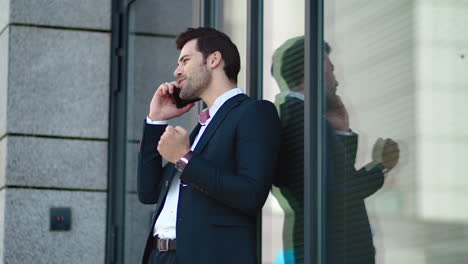 Closeup-businessman-talking-phone-outside.-Business-man-using-smartphone