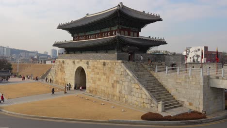 travellers visiting hwaseong fortress north gate in suwon city, south korea in winter