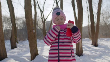 a young girl takes a selfie in a snowy forest