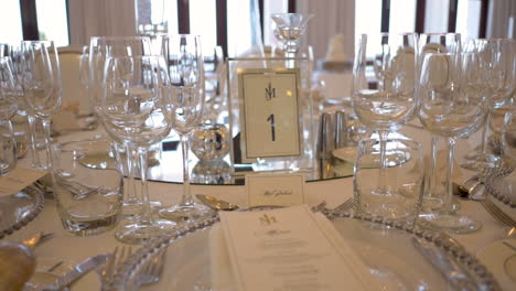 beautiful table setting at luxury hotel wedding with glassware and menus