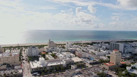 miami city blocks on shining atlantic ocean shore on hot sunny day, aerial