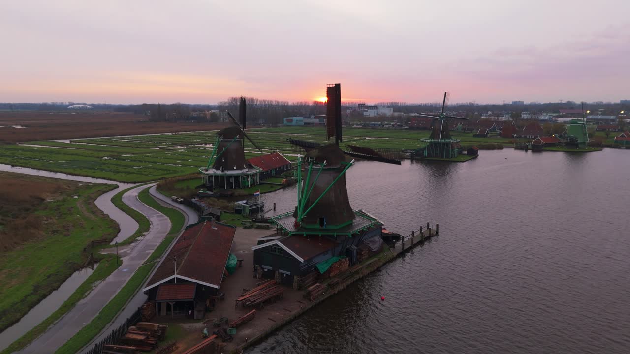 Dronevideo of the Windmills of zaanse schans (close to Amsterdam) in the early dawn lights.