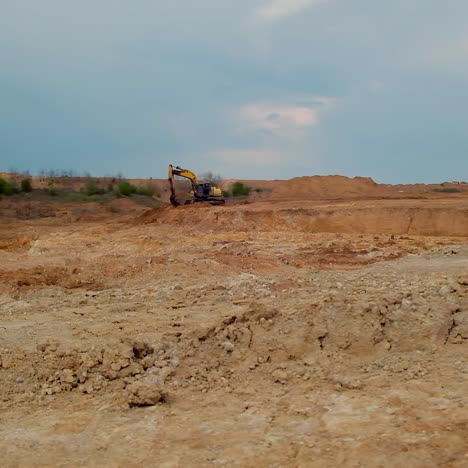 Excavator has prepared the site for future construction. The territory with dug ground cleaned from plants for building purposes